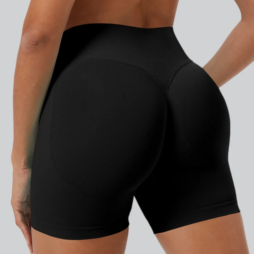 A close-up shot of a woman wearing black seamless high-waist yoga leggings.