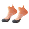 A pair of orange and gray breathable anti-blister running socks shown flat.