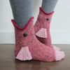 Pair of fuzzy pink knit socks shaped like crocodiles for holiday parties