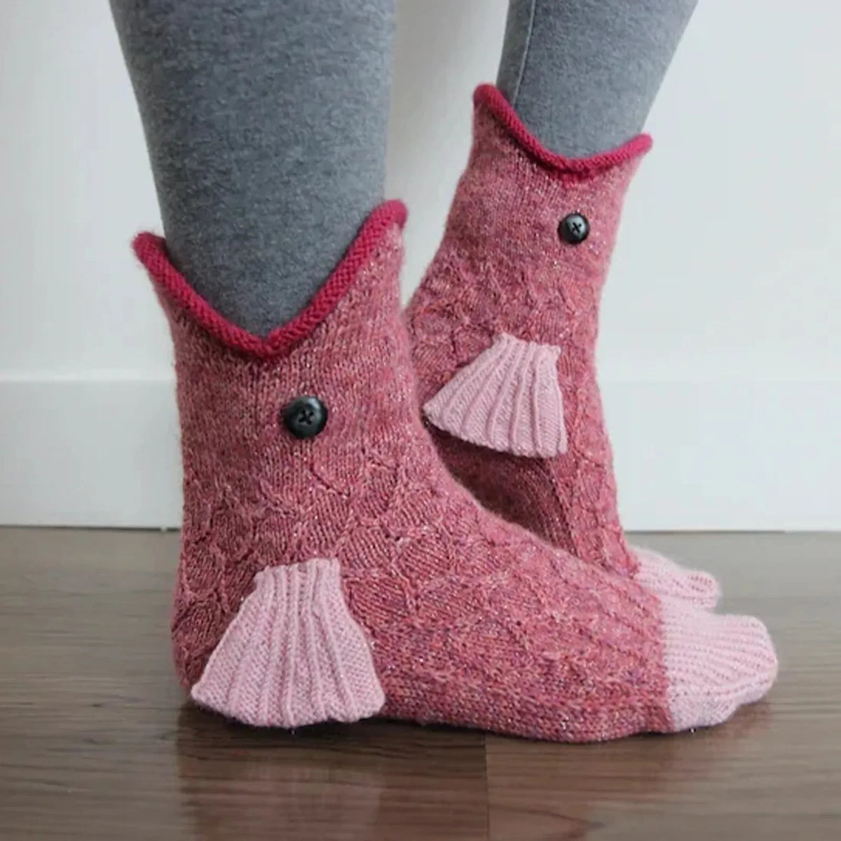 Pair of fuzzy pink knit socks shaped like crocodiles for holiday parties