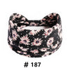 Bandeau en coton extensible à motifs floraux noirs porté autour de la tête