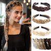 A woman models a twisted braided wig headband in brown and beige tones.