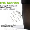 A close-up of a black sports shaker bottle with a metal whisk ball shown next to some thin metal wires.