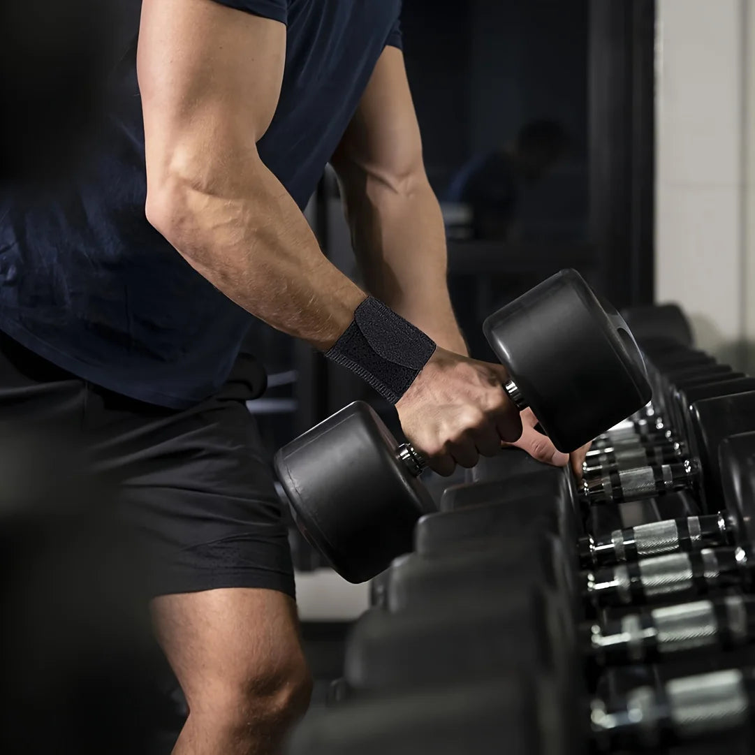 A person is using black wrist support straps on a piece of gym equipment for pain relief.