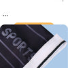 Close-up of black and white striped sports arm sleeves rolled up, showing the fabric texture.