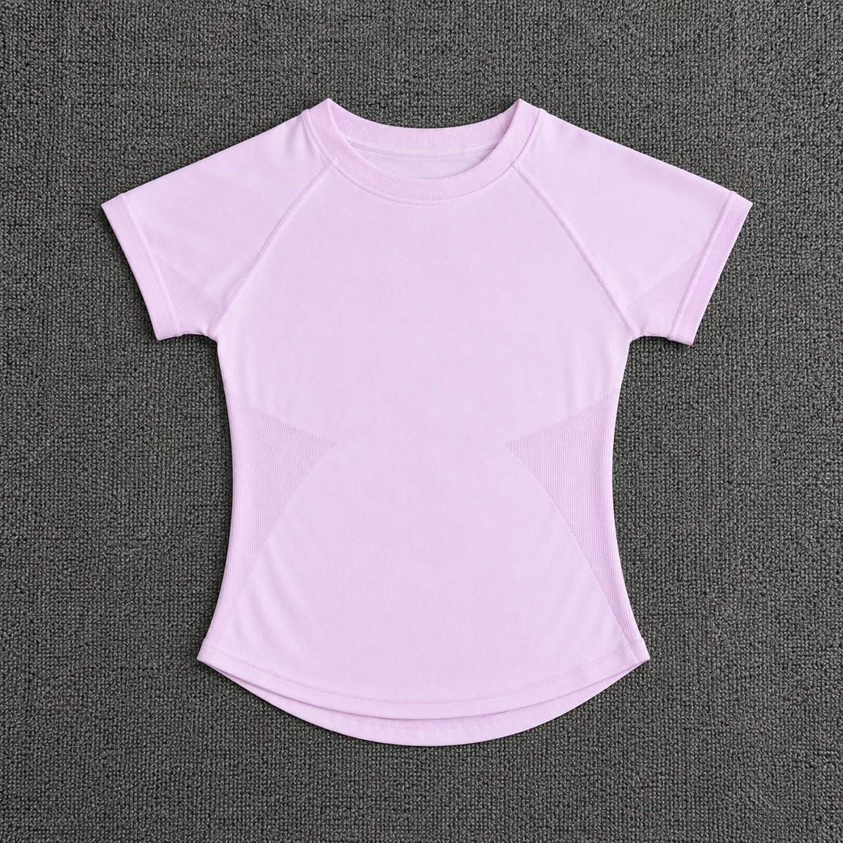 A light pink seamless high-waist yoga top for women shown against a dark gray background.