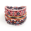 A stack of colorful bohemian stretch cotton headbands featuring geometric patterns in orange, pink, and black.