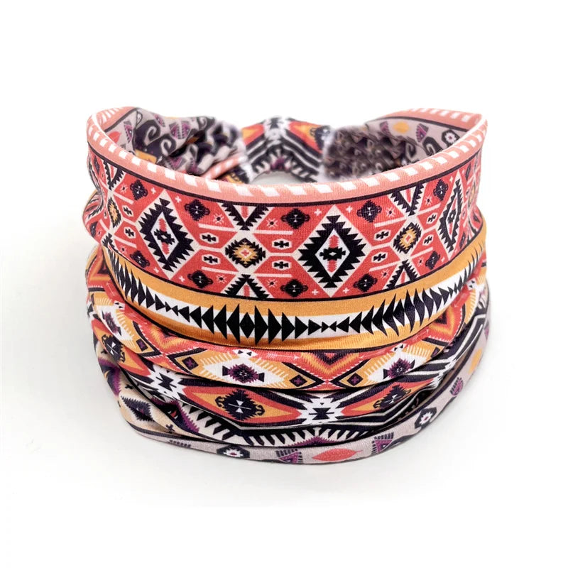 A stack of colorful bohemian stretch cotton headbands featuring geometric patterns in orange, pink, and black.