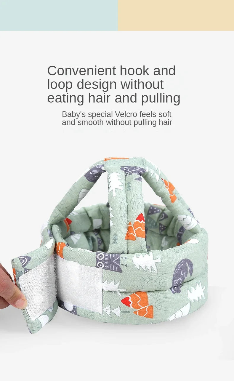 A soft adjustable safety helmet for toddlers featuring a Velcro hook and loop design with a patterned fabric.