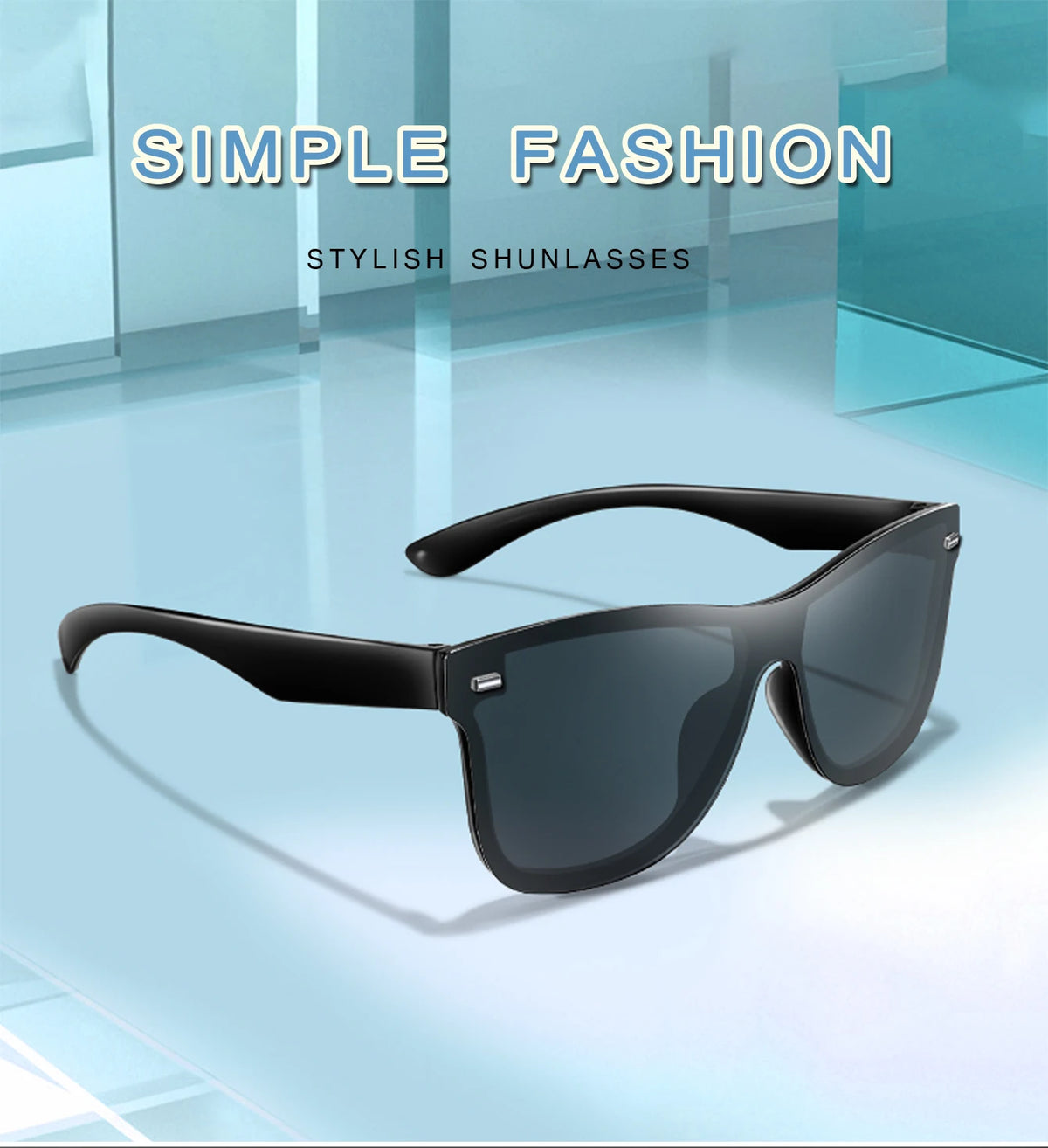 A pair of black frameless sunglasses resting on a light blue surface.