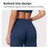 A model wearing dark blue high-waist yoga leggings showing a rounded and lifted buttock line.