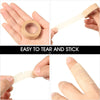 A set of natural colored tape rolls and a wooden applicator for eyelash extension application.