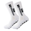 A pair of white anti-slip performance sports socks with black text and dots.