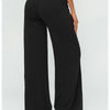 Black flared high-waist yoga pants shown from the rear view