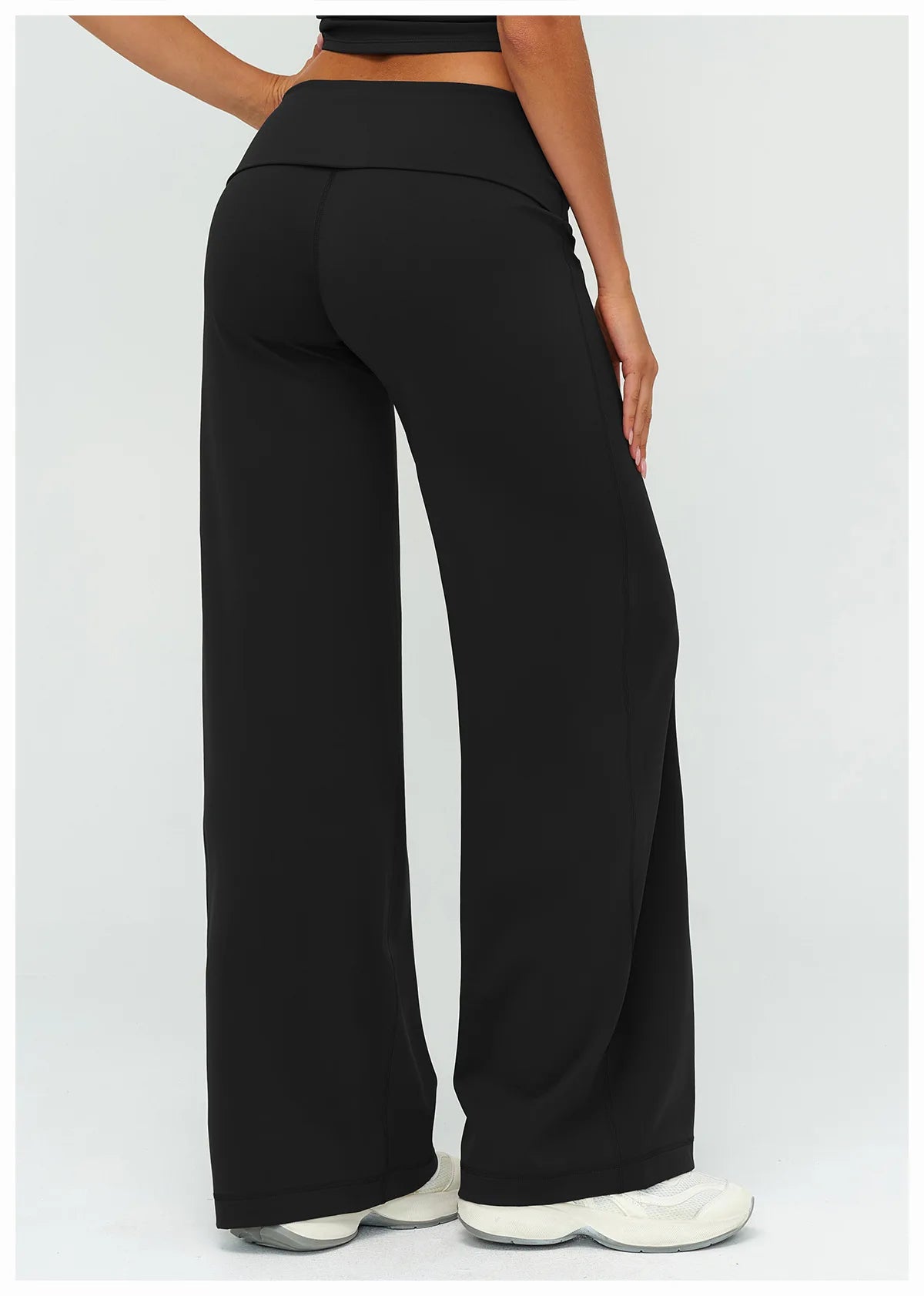 Black flared high-waist yoga pants shown from the rear view
