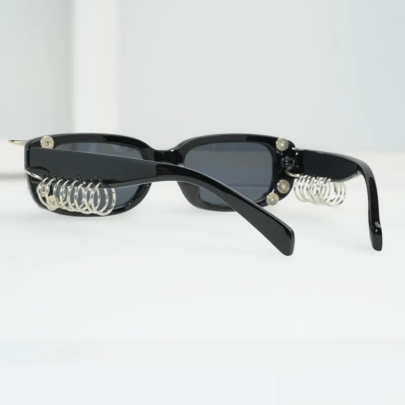 Black sunglasses with spiked rivets and silver chain accents