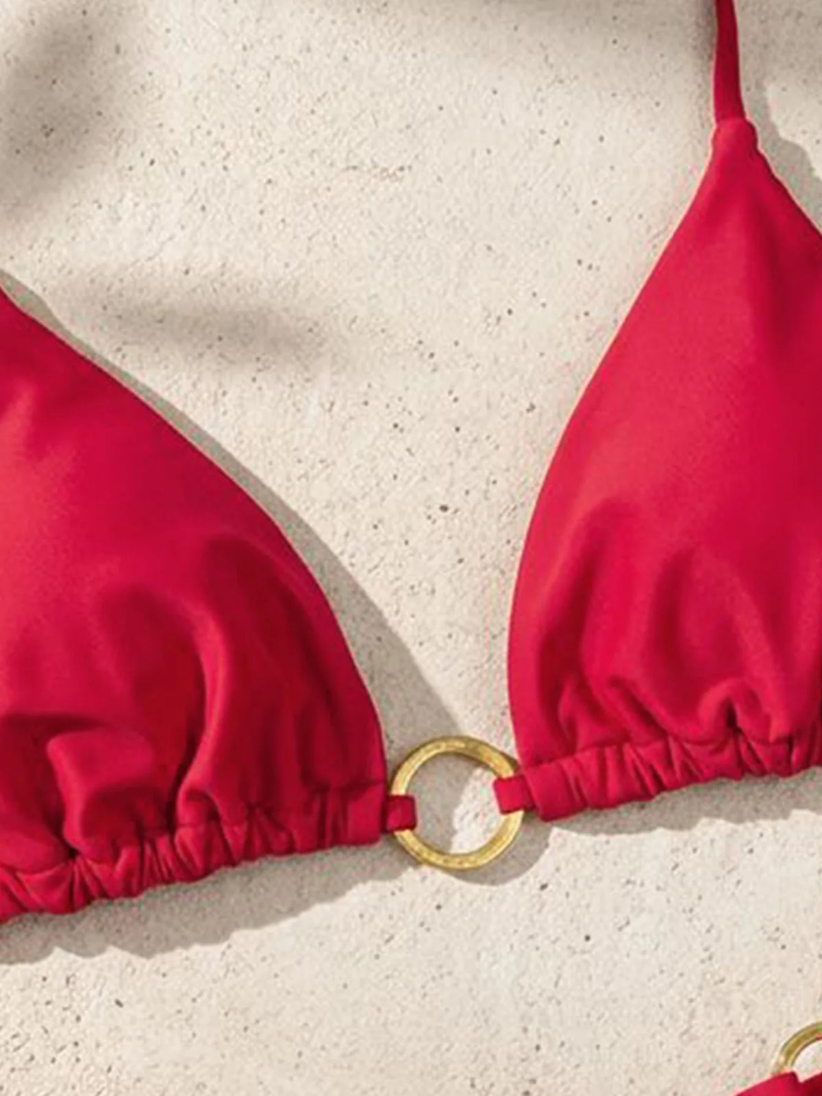 A bright red tie-side low rise bikini top shown against a light background.