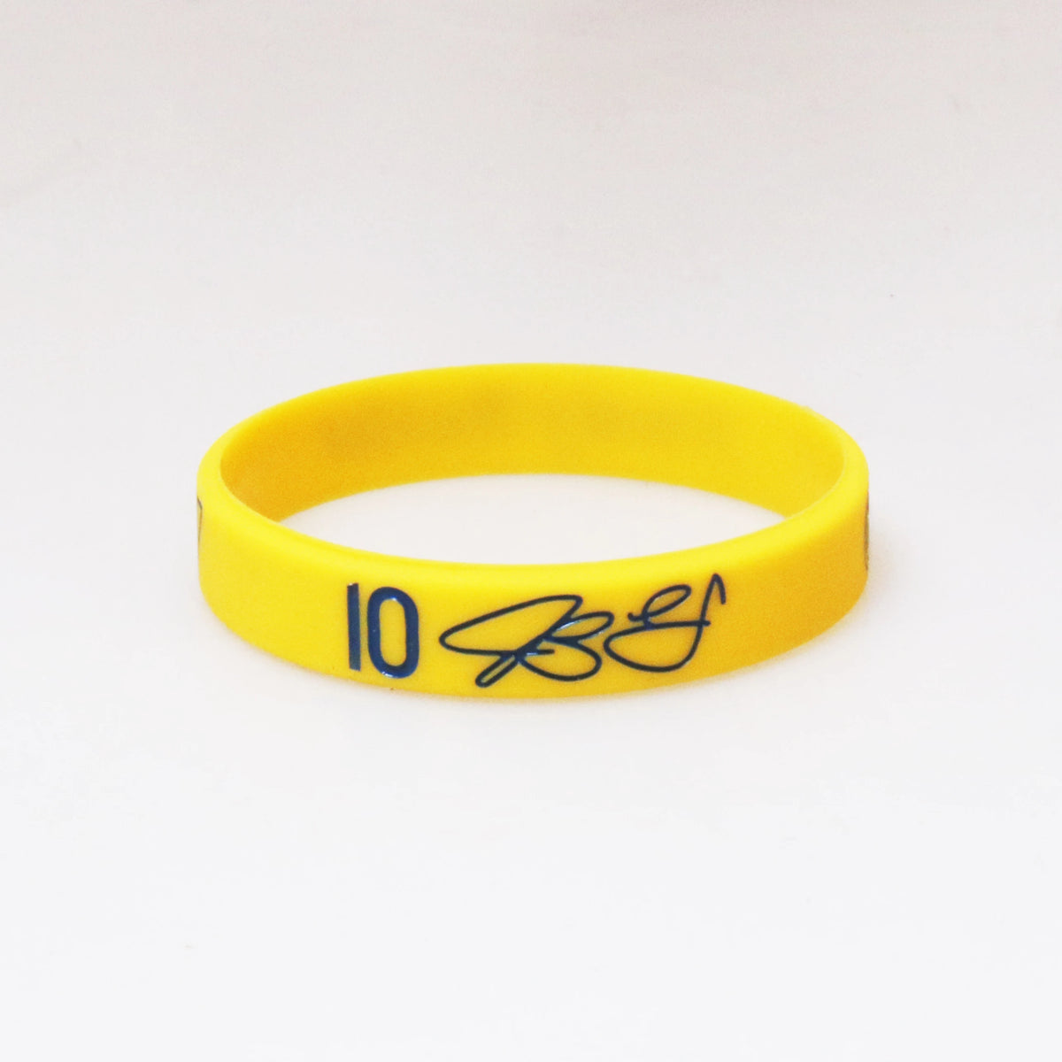 Yellow silicone wristband with the number 10 and a signature printed on it.