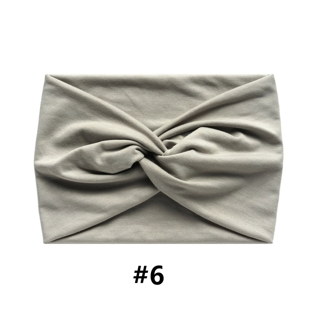 A light gray fabric item, likely a boho wide turban headband, is folded and displayed against a white background.
