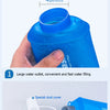 A hand holds a blue sports water bottle, demonstrating its large water outlet and a special dust cover with a suction nozzle.
