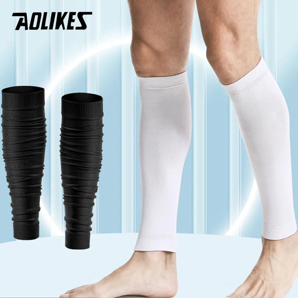 A pair of white compression leg sleeves being worn on a person's legs.