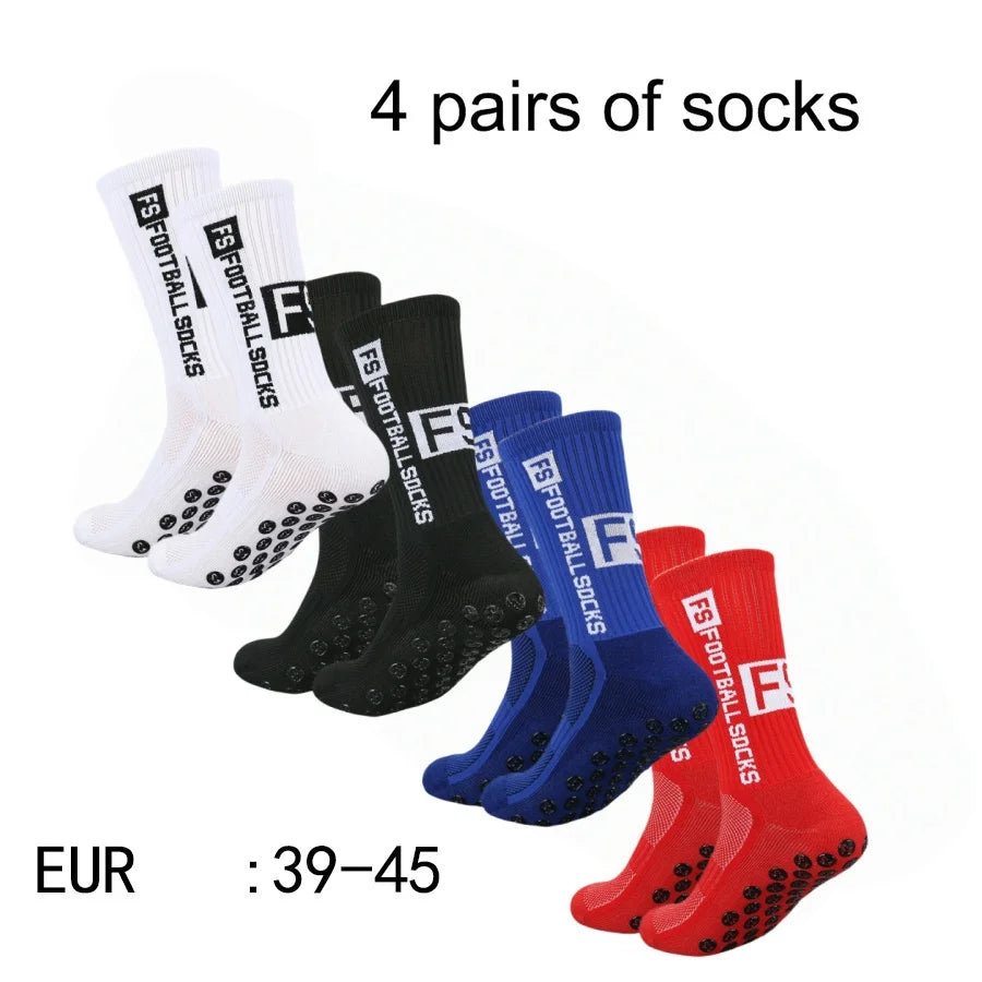 Four pairs of black, white, and blue athletic soccer socks with non-slip grips.