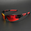 A pair of wraparound sports sunglasses with red and black frames and an orange-tinted lens resting on a dark surface.