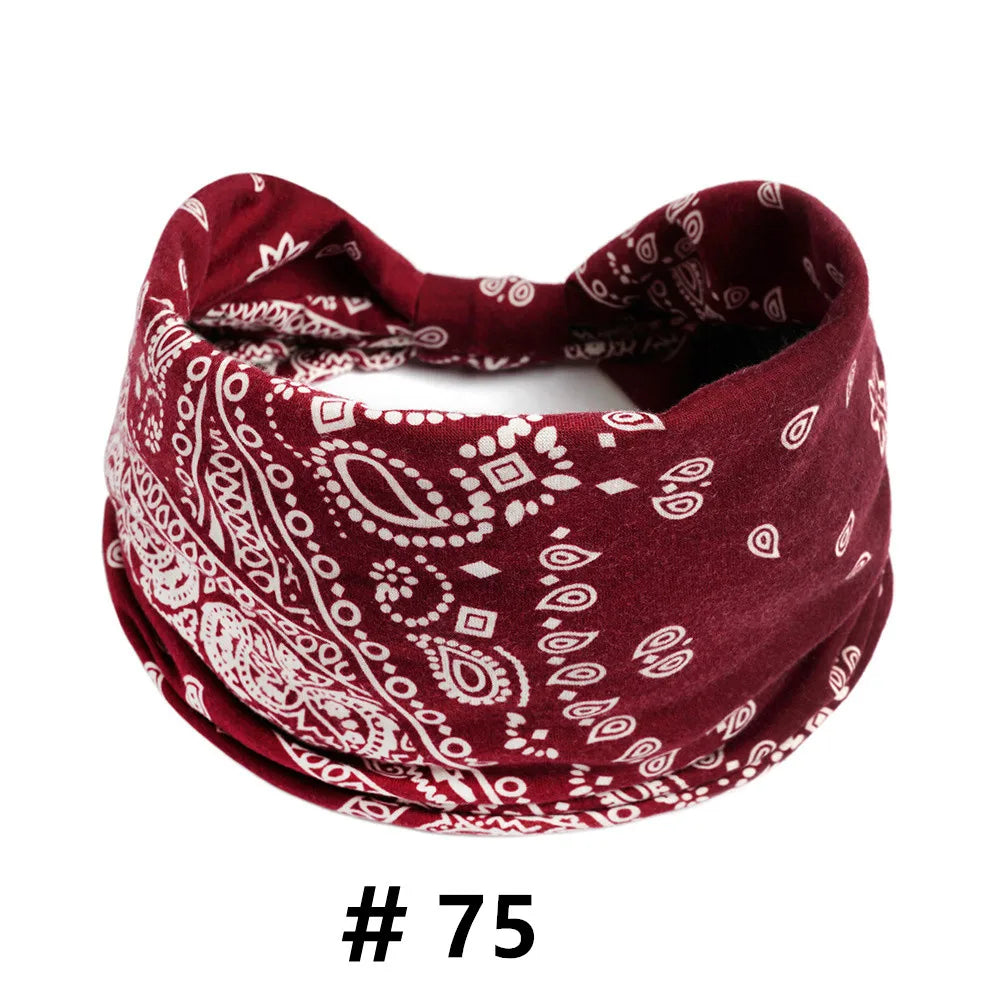 A burgundy boho print cotton headband tied in a knot.