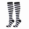A pair of black and white striped compression elastic socks for sports and daily wear.