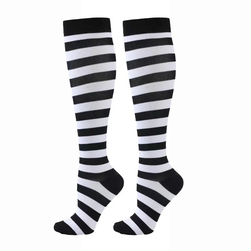 A pair of black and white striped compression elastic socks for sports and daily wear.