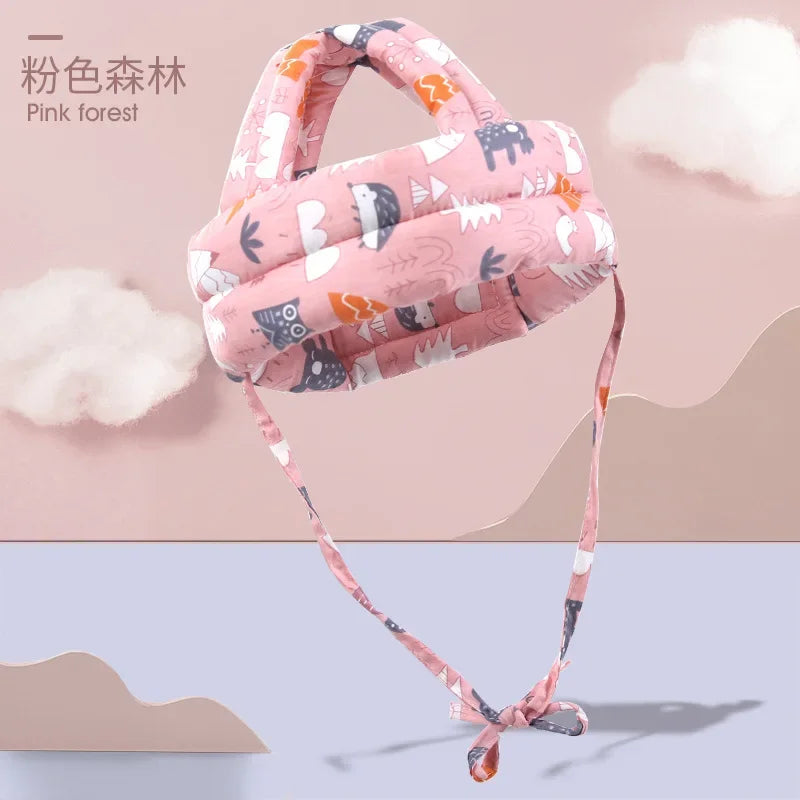 Pink forest soft adjustable safety helmet for toddlers with a pink fabric and strap