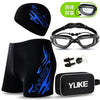 Black men's swim suit with blue flame design, goggles, cap, and earplugs