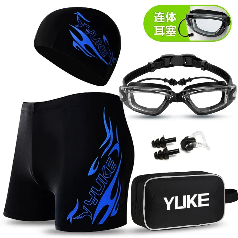 Black men's swim suit with blue flame design, goggles, cap, and earplugs