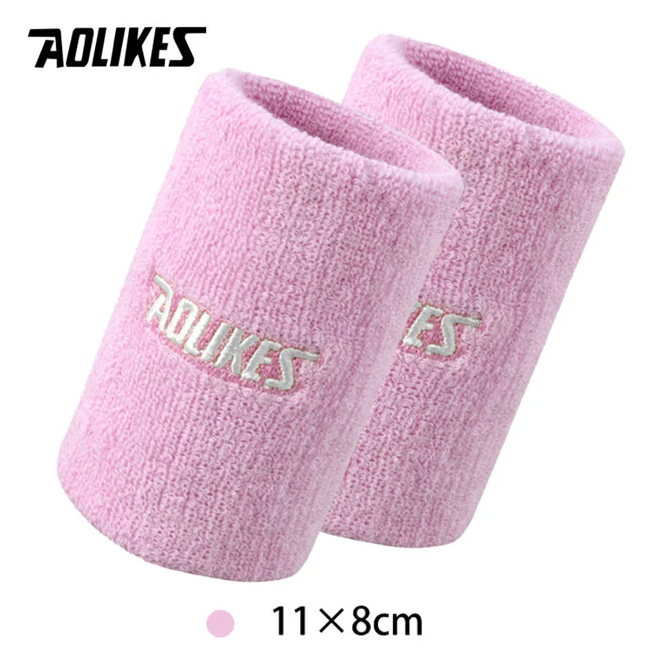 A pair of pink knitted sport wristbands shown flat, measuring 11x8cm.