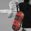 A red and black patterned pouch with a zipper is shown attached to a keychain, held by a person.
