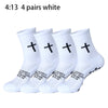 Four pairs of white prayer and cross grip sports socks shown in a row.