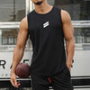 A muscular man wearing a black sleeveless sports tank top and black athletic pants, holding a brown leather football.