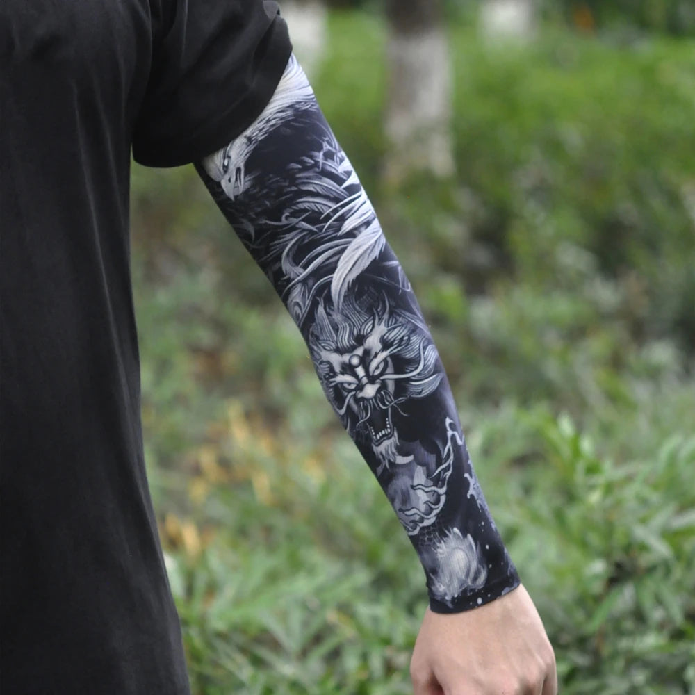A person is wearing a black long sleeve shirt and a black and white ice silk tattoo sleeve on their arm.