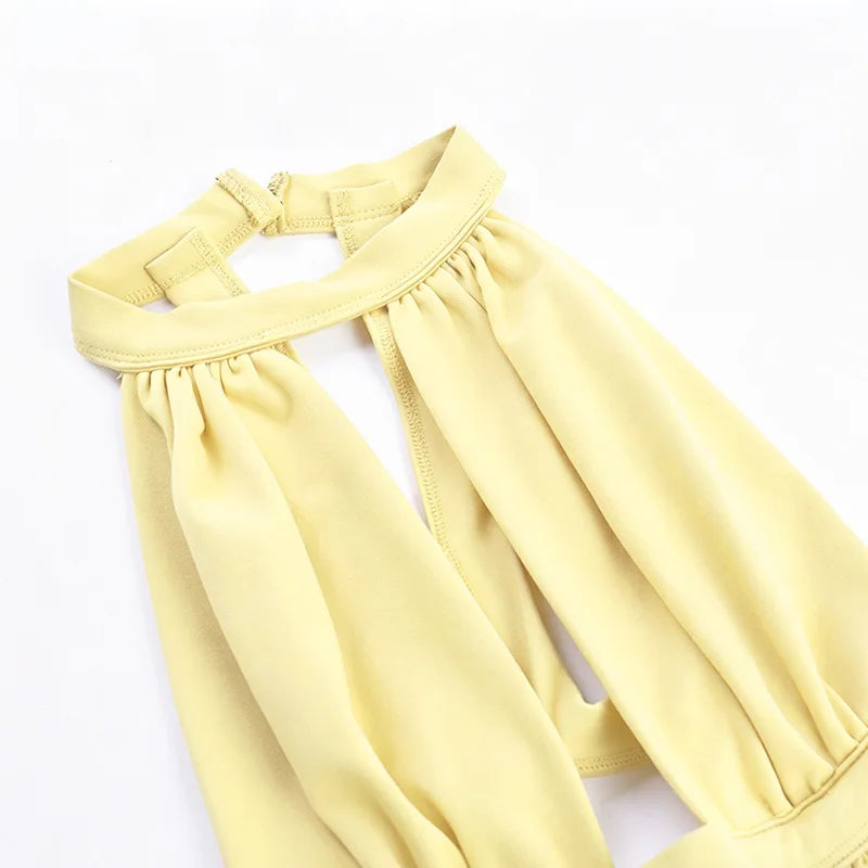 A yellow, gathered-neck dress with a draped cut-out back shown from the front.