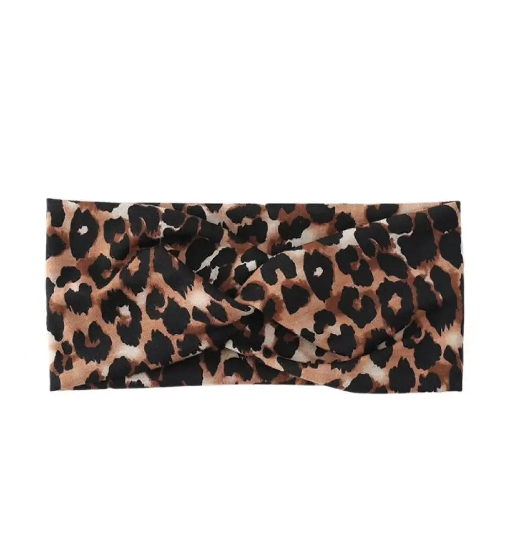 A black and brown leopard print wide headband for yoga and running.