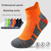 A pair of orange and gray running socks displayed on a white background with various colors shown in the background.