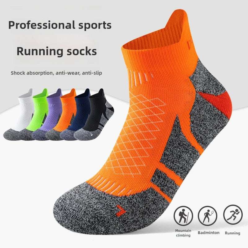 A pair of orange and gray running socks displayed on a white background with various colors shown in the background.