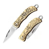 A brass folding knife with an ornate handle and blade, shown against a white background.