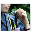 A hand is shown holding a black straw accessory attached to a pink water bottle inside a dark blue backpack.