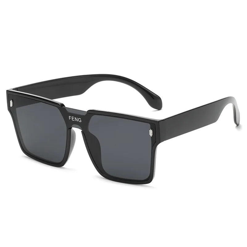 Black oversized square sunglasses with a dark lens and a silver accent detail