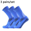 Three pairs of blue performance football socks laid out for sale