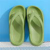 A pair of light green comfort platform flip flops shown against a blue background.