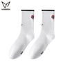 A pair of white crew socks with red and black trim for athletic activities