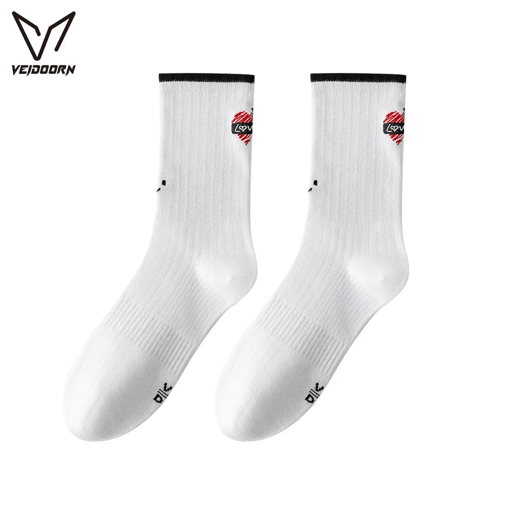 A pair of white crew socks with red and black trim for athletic activities