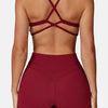 A model wearing a maroon high-support sports bra and matching leggings, shown from the back.